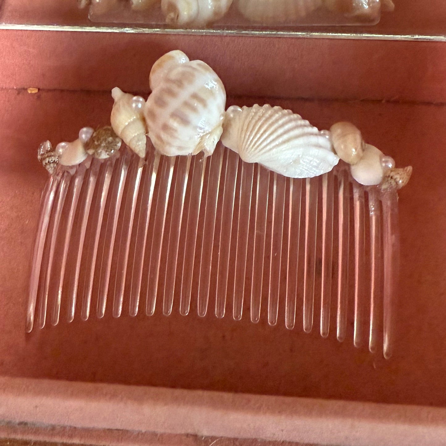 Pink jewelry box a with seashell hair comb inside