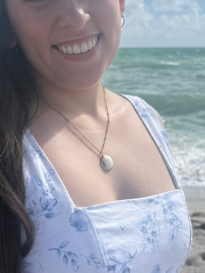 woman wearing seashell necklace on the beach
