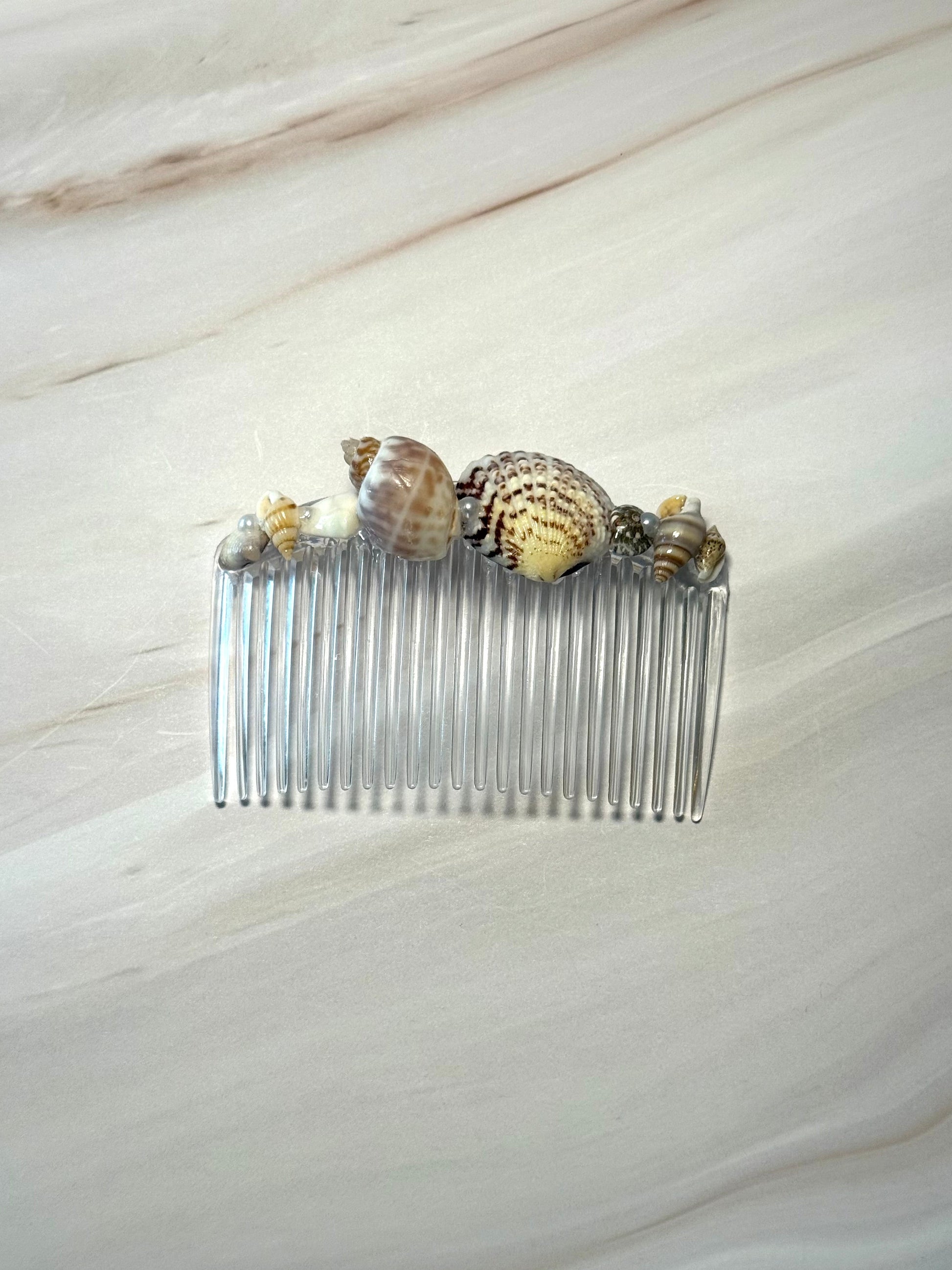 Seashell Hair comb on a marble background