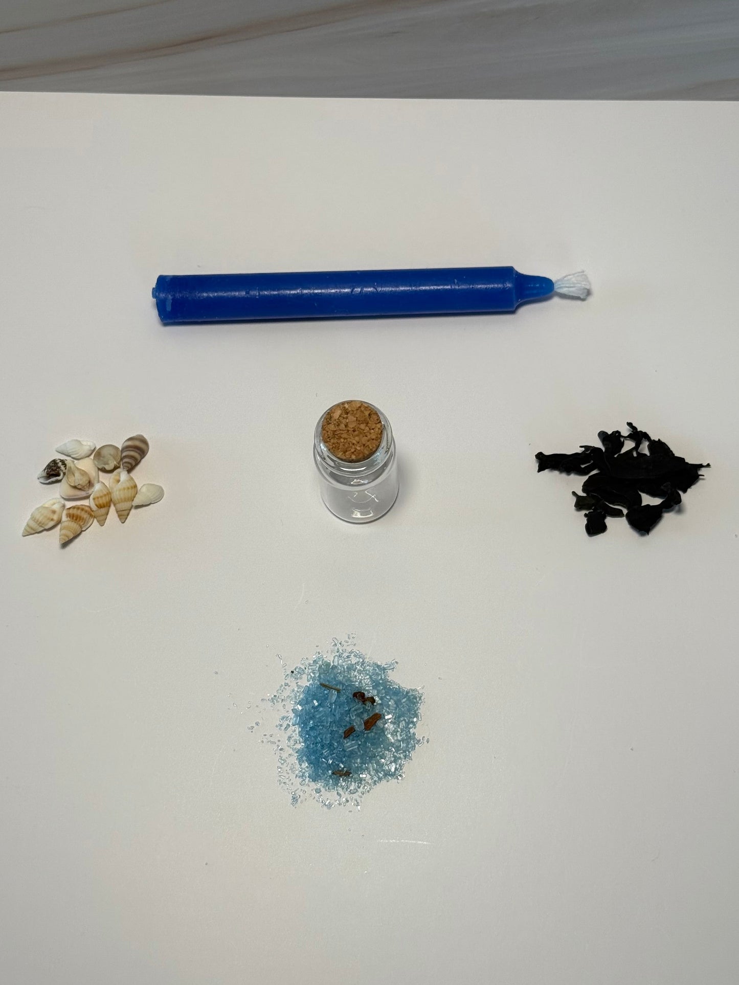 Spell ingredients laid out on a white background