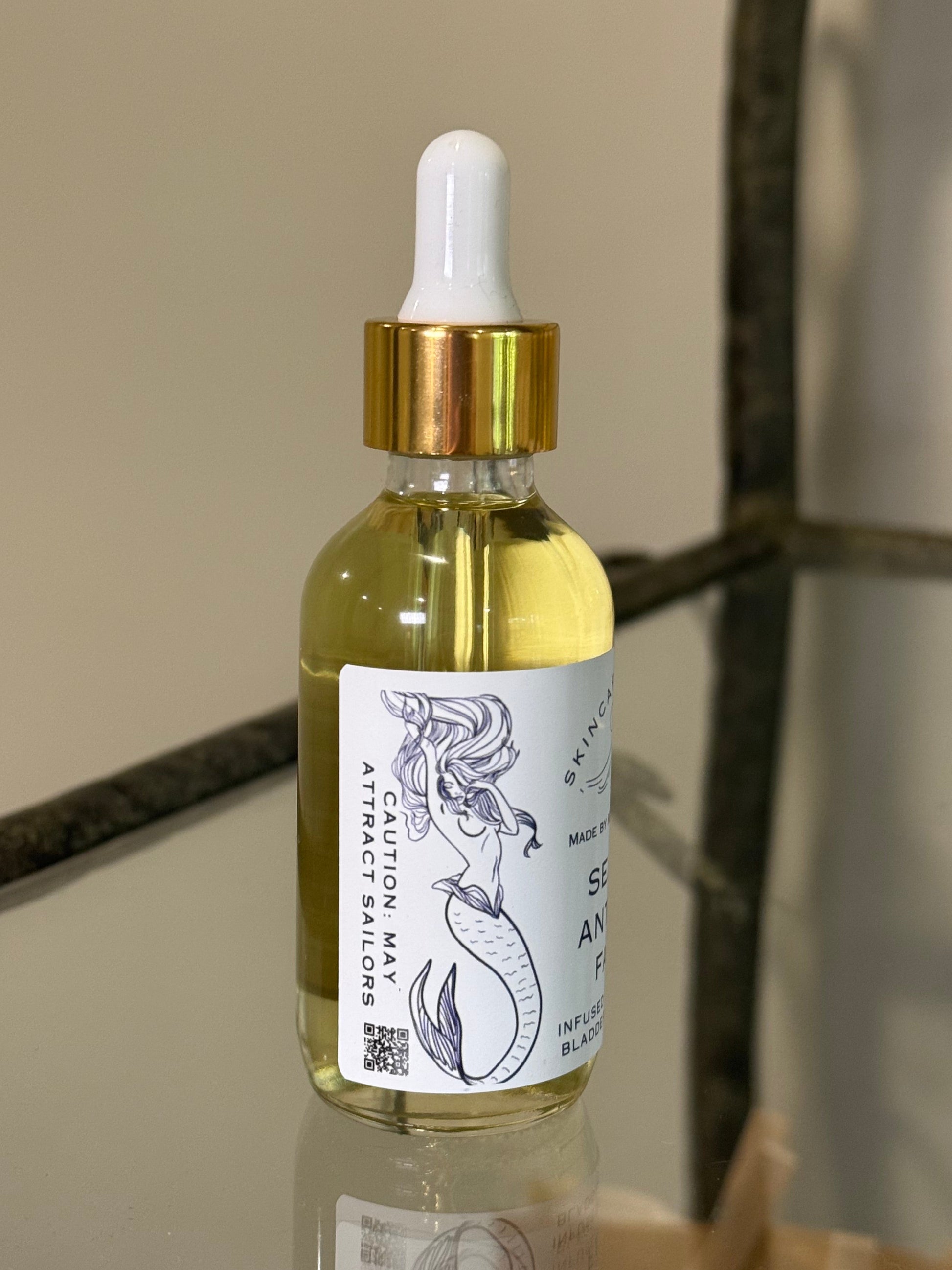 Bottle with dropper and label showing a mermaid