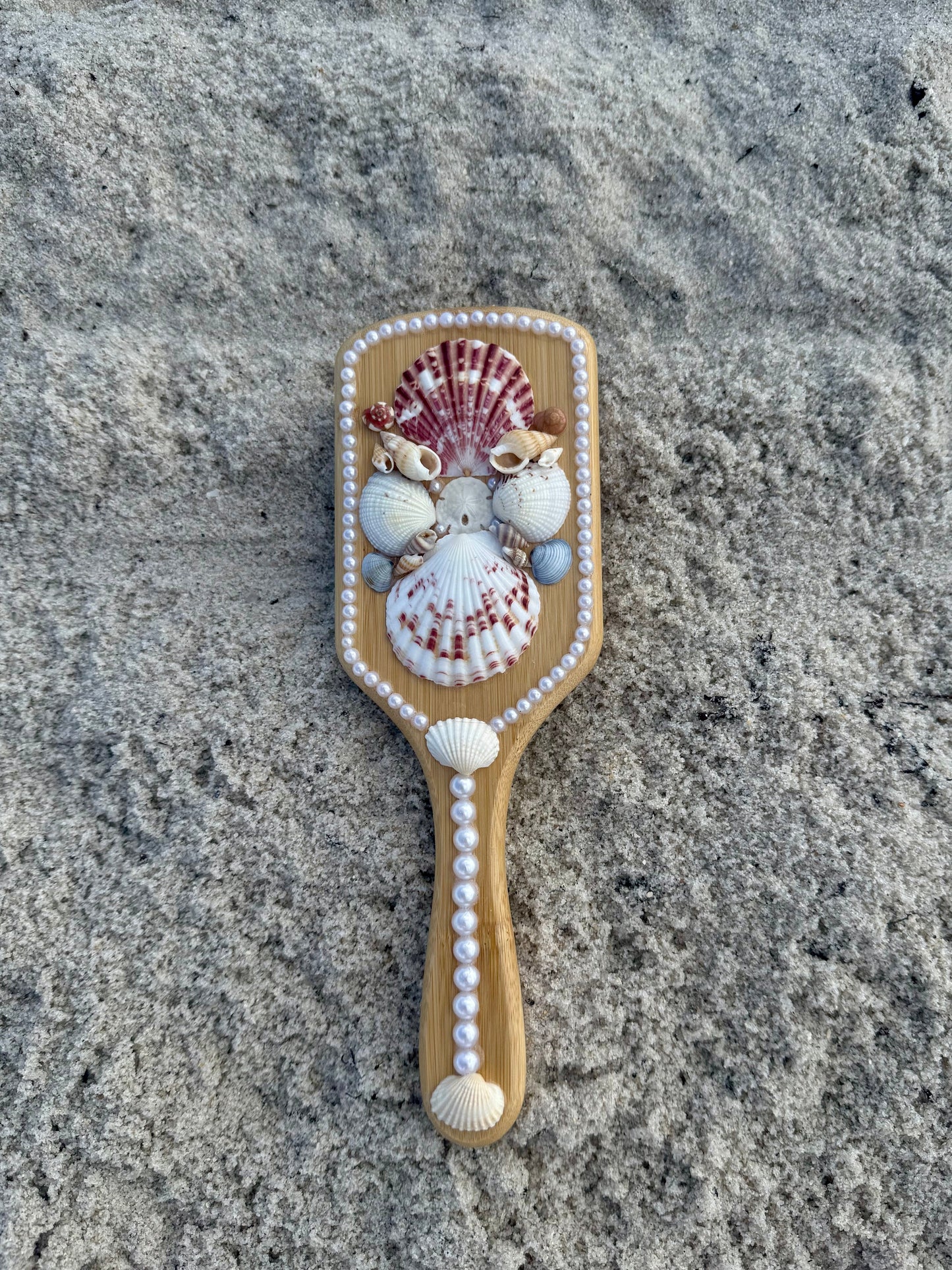 Mermaid seashell hair brush in the sand