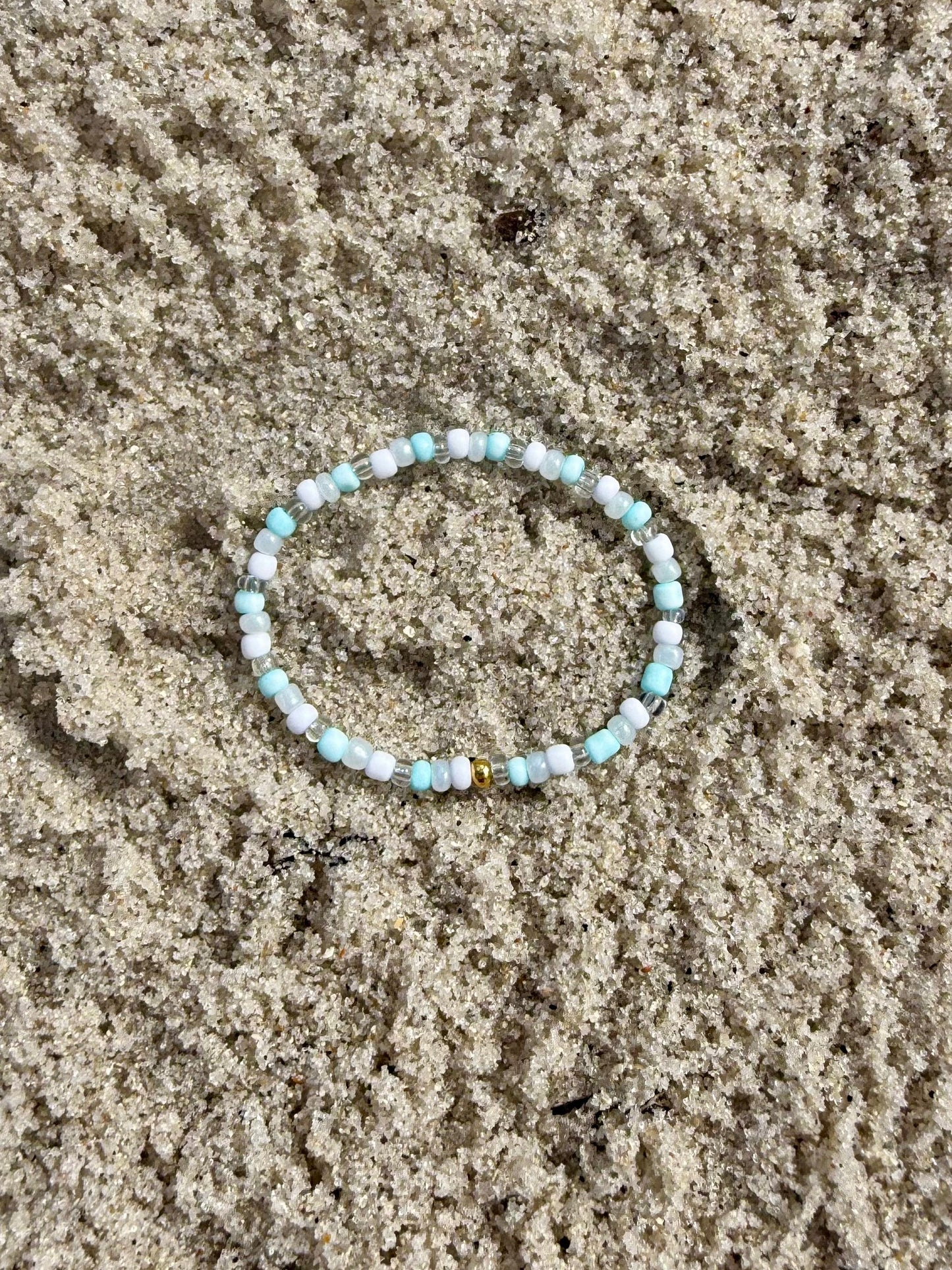 Beaded bracelet on sand