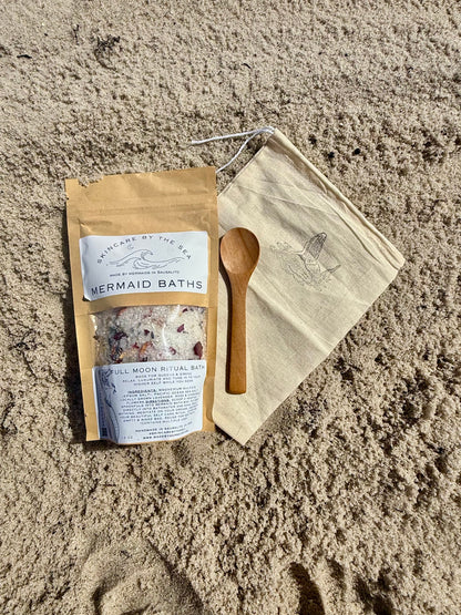 mermaid Bath salts in package with bag and scoop on the sand