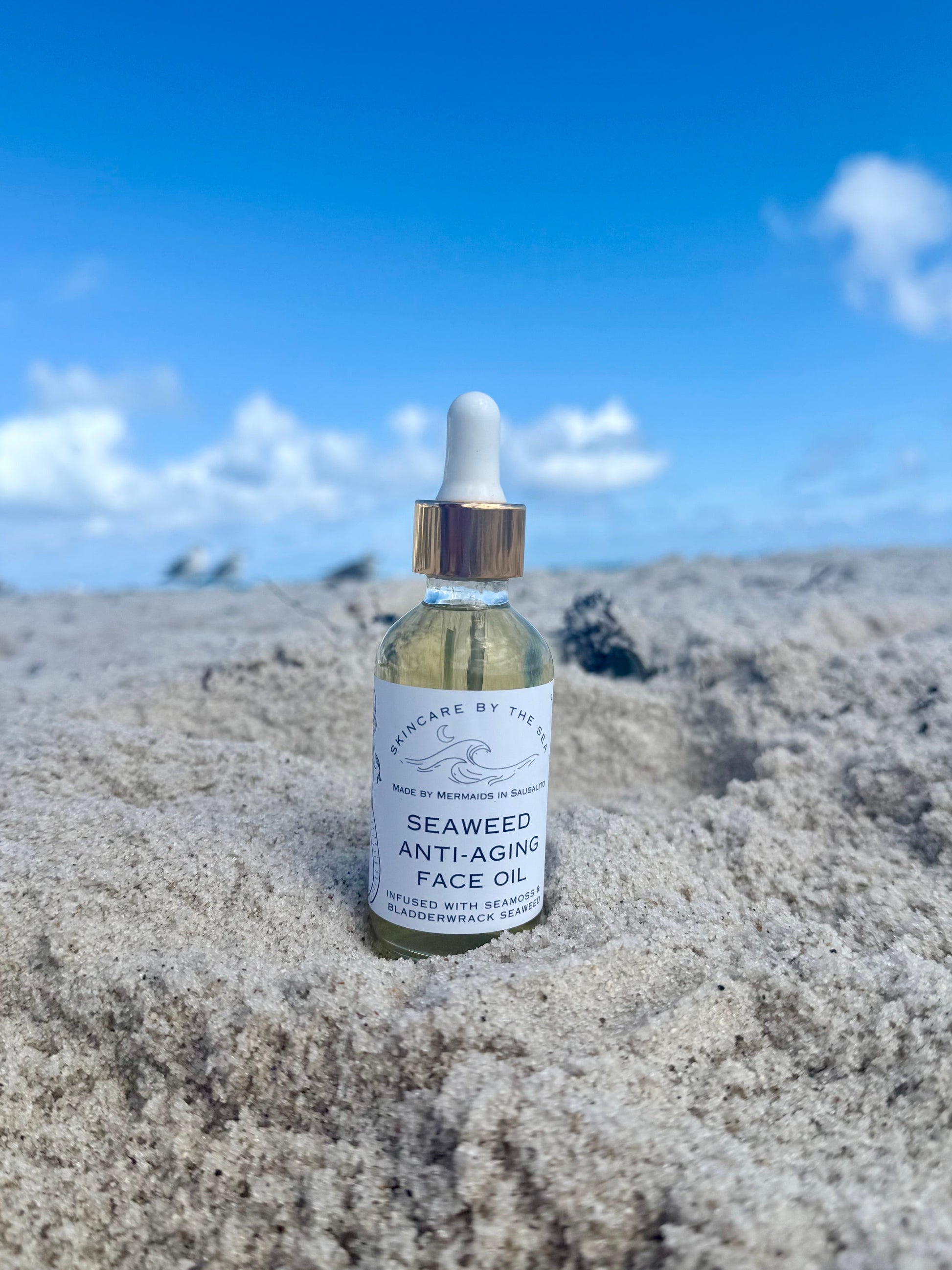 Face oil on a beach with sand and sky background