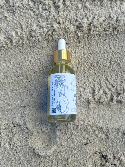 bottle with a mermaid on it on a sandy background
