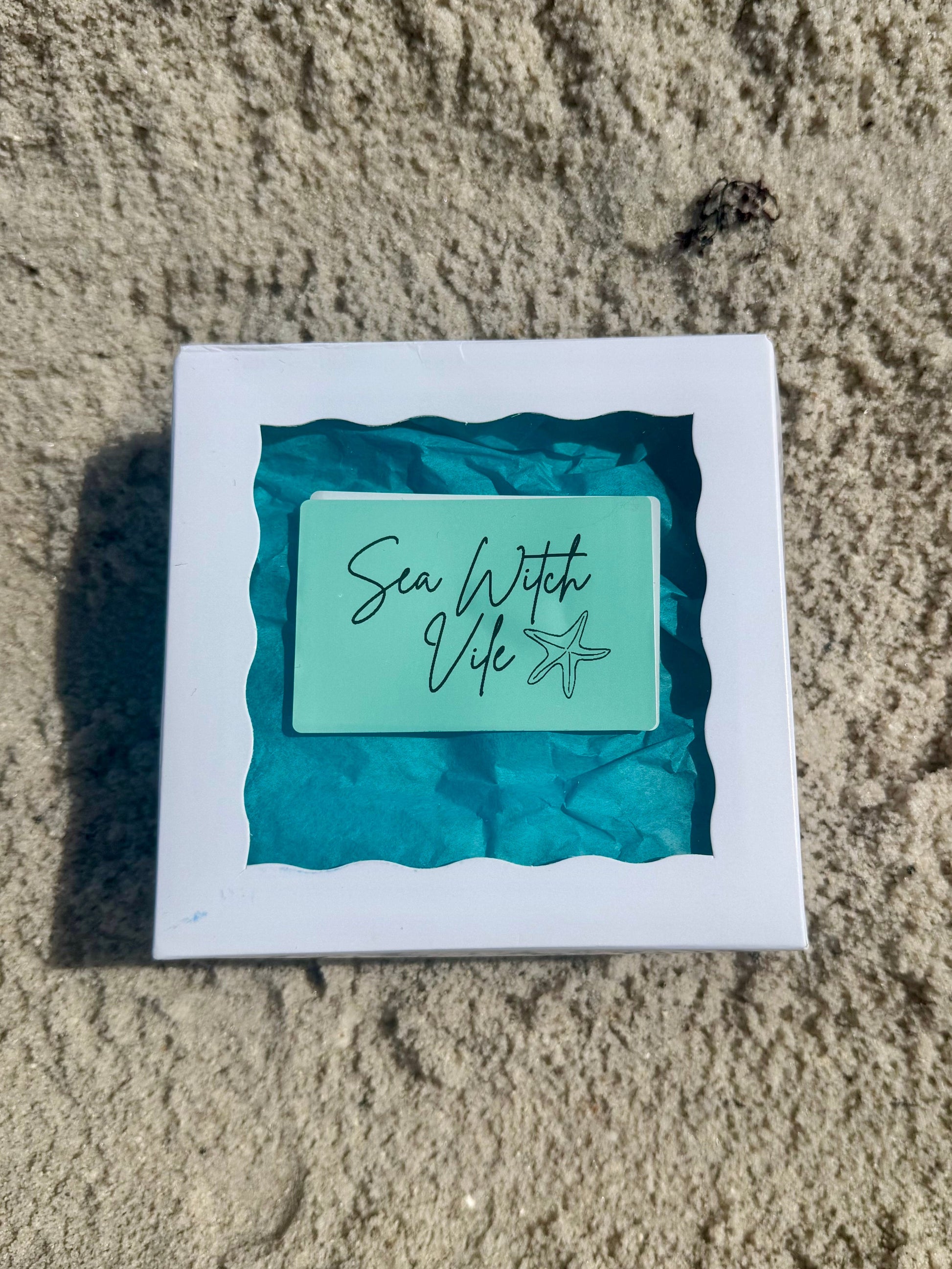 Sea Witch Vile Spell box on the sand