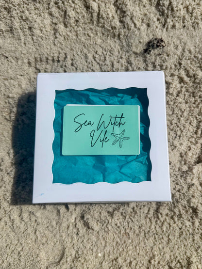 Sea Witch Vile Spell box on the sand