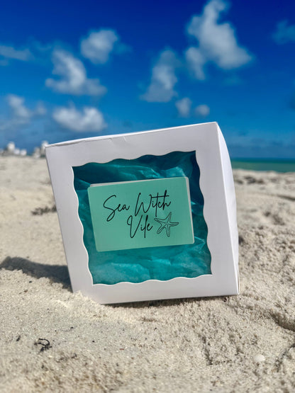 sea witch vile box on a beach with sand and blue sky