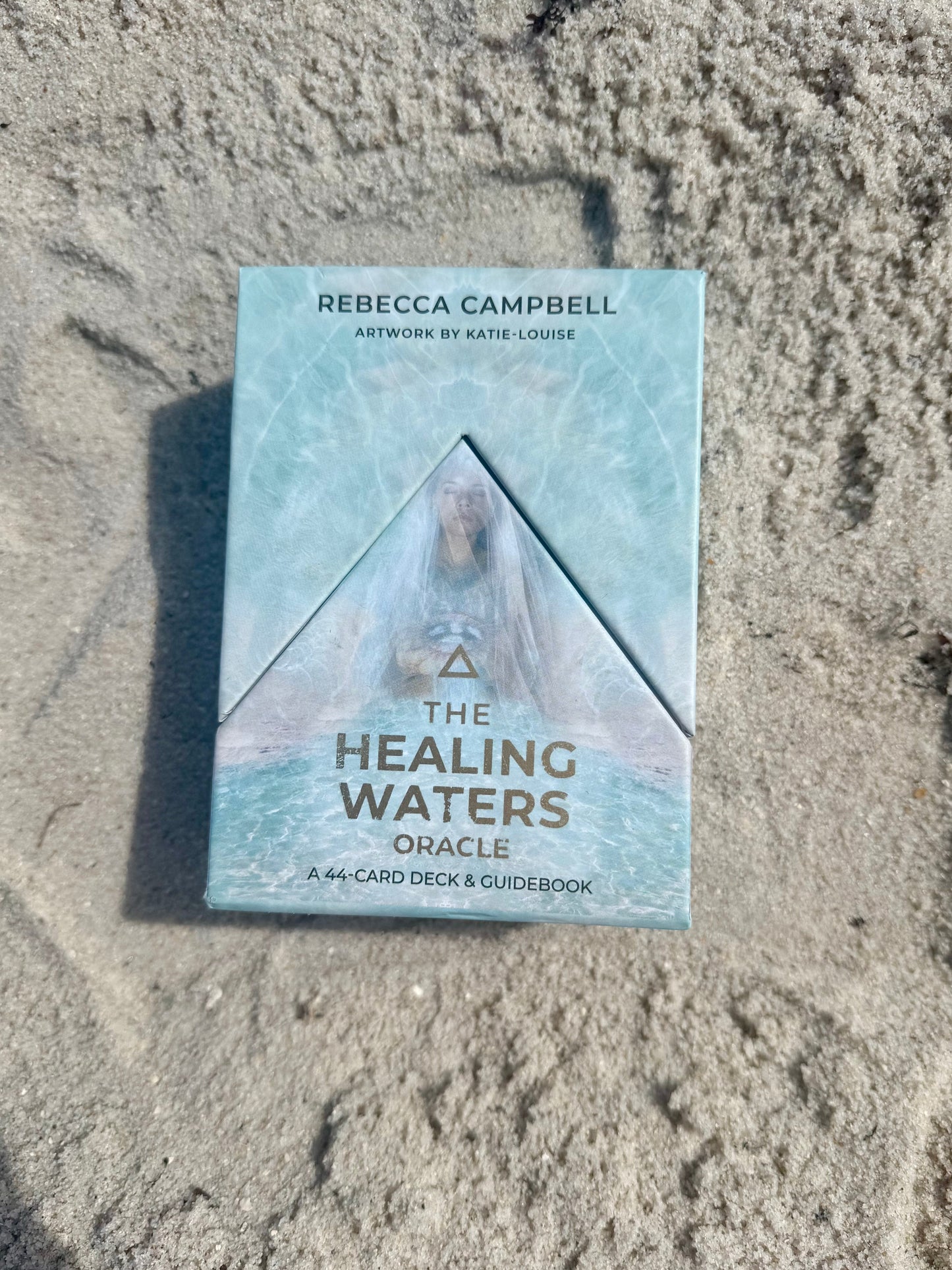 Healing Waters Oracle card deck on sand