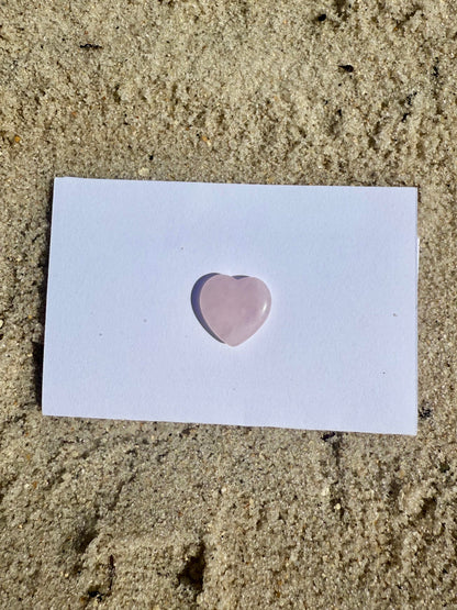 Rose Quartz Crystal Heart on the sand