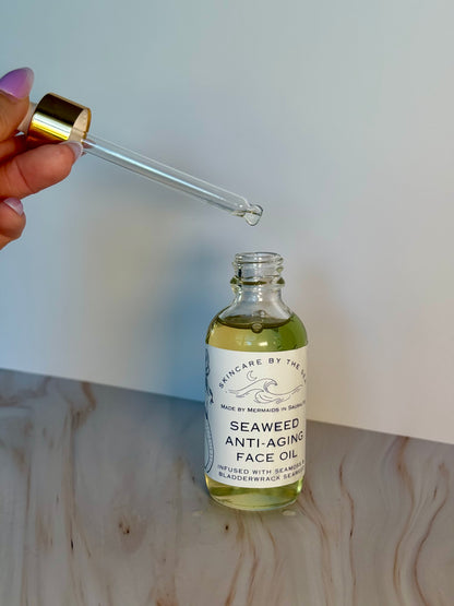 Seaweed anti-aging face oil with dropper on a light wooden surface