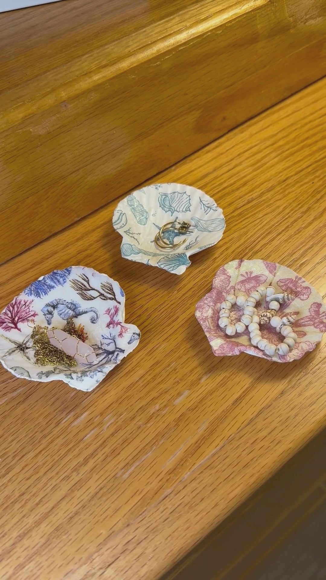 video of seashell trinket dishes showing the front and back as well as displayed with jewelry.